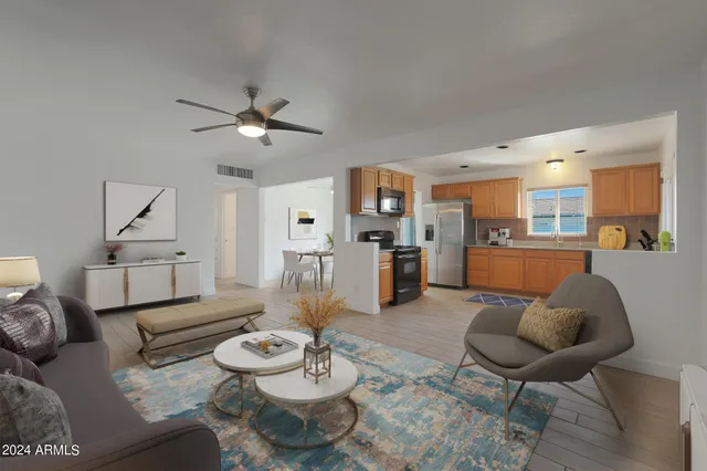 a living room with furniture and kitchen view