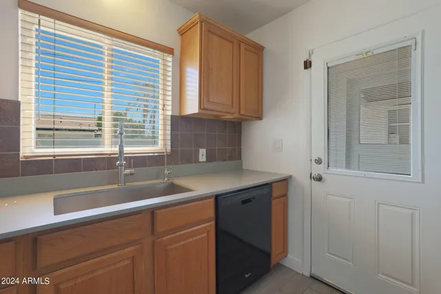 a kitchen with a sink and cabinets