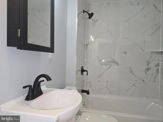 a bathroom with a sink a toilet and a bathtub