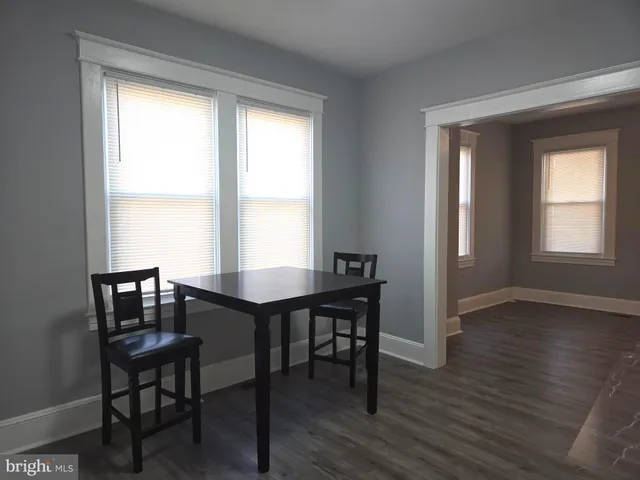 a view of a dining room with furniture and window