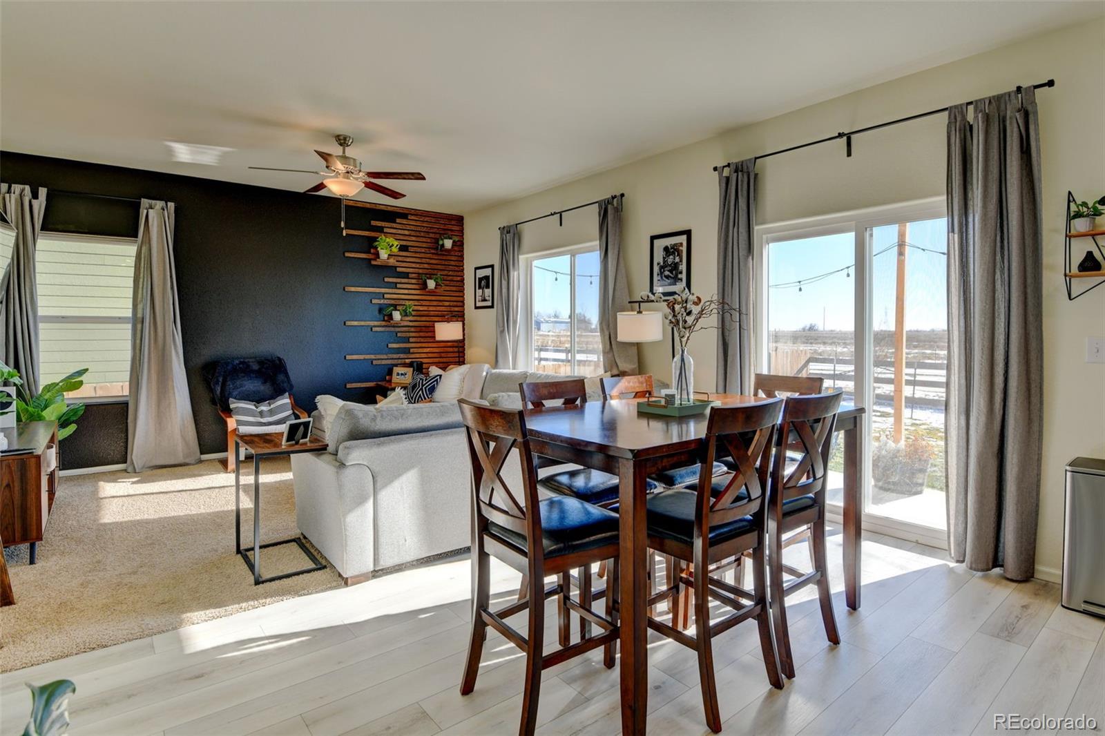 7252 Fall River Circle Frederick, CO 80530 - Photo 13 of 31 a dining room with a wooden table and chairs