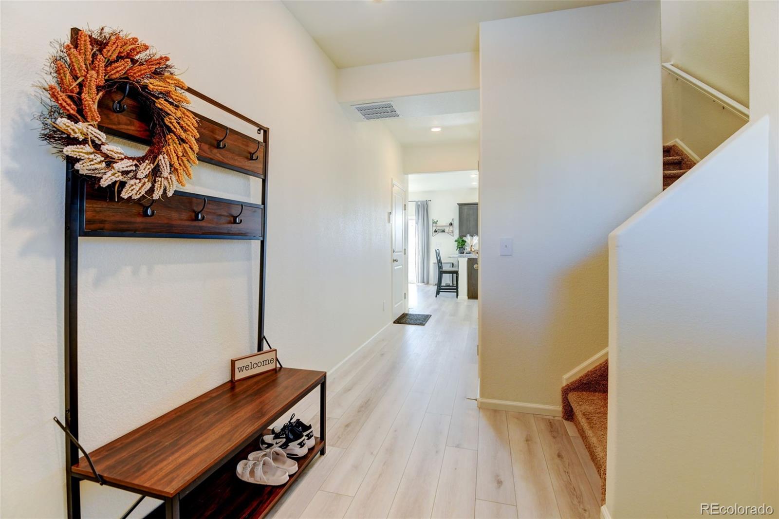 7252 Fall River Circle Frederick, CO 80530 - Photo 4 of 31 a hallway with wooden floor