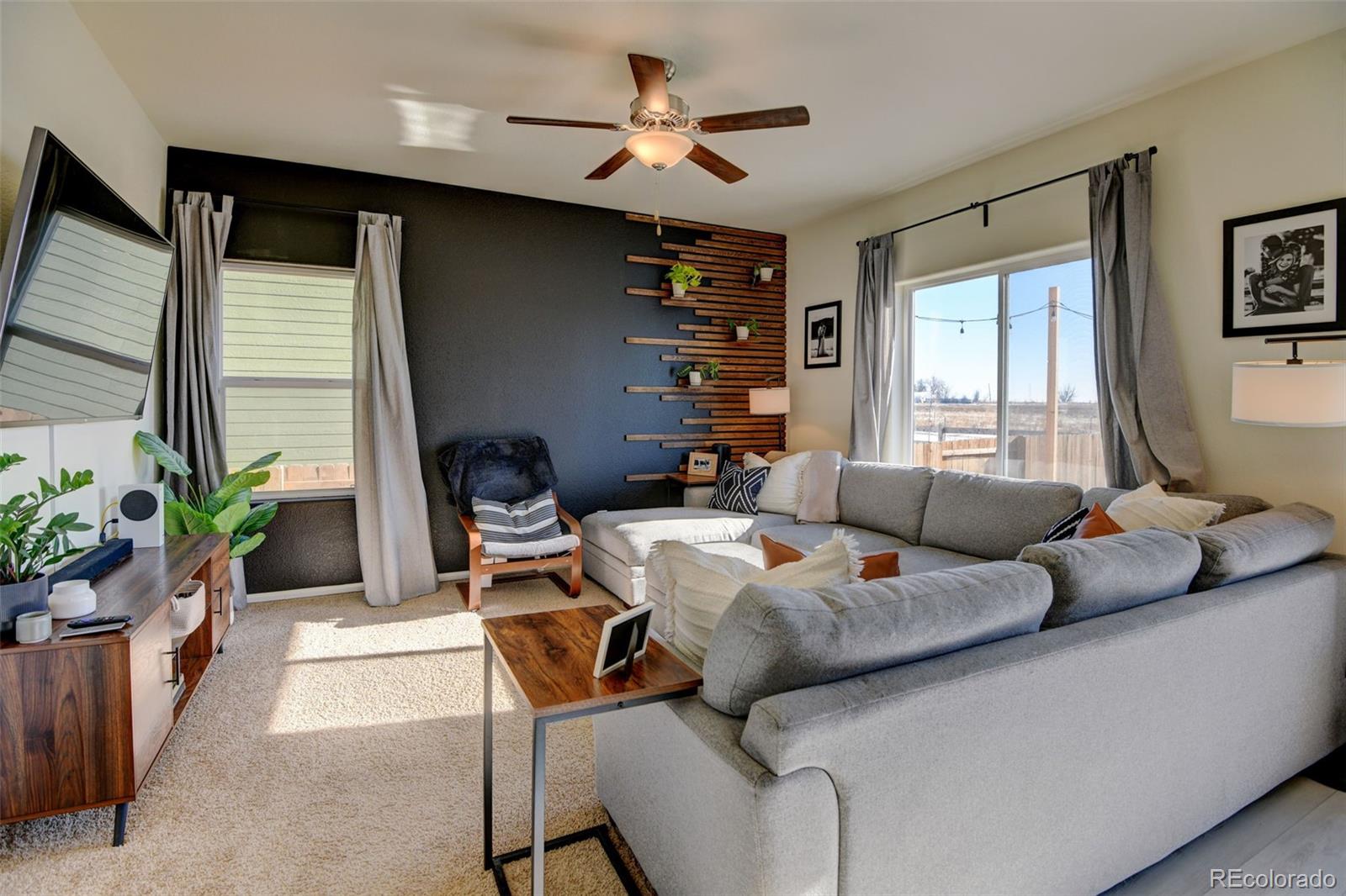 7252 Fall River Circle Frederick, CO 80530 - Photo 6 of 31 a living room with furniture potted plant and a window