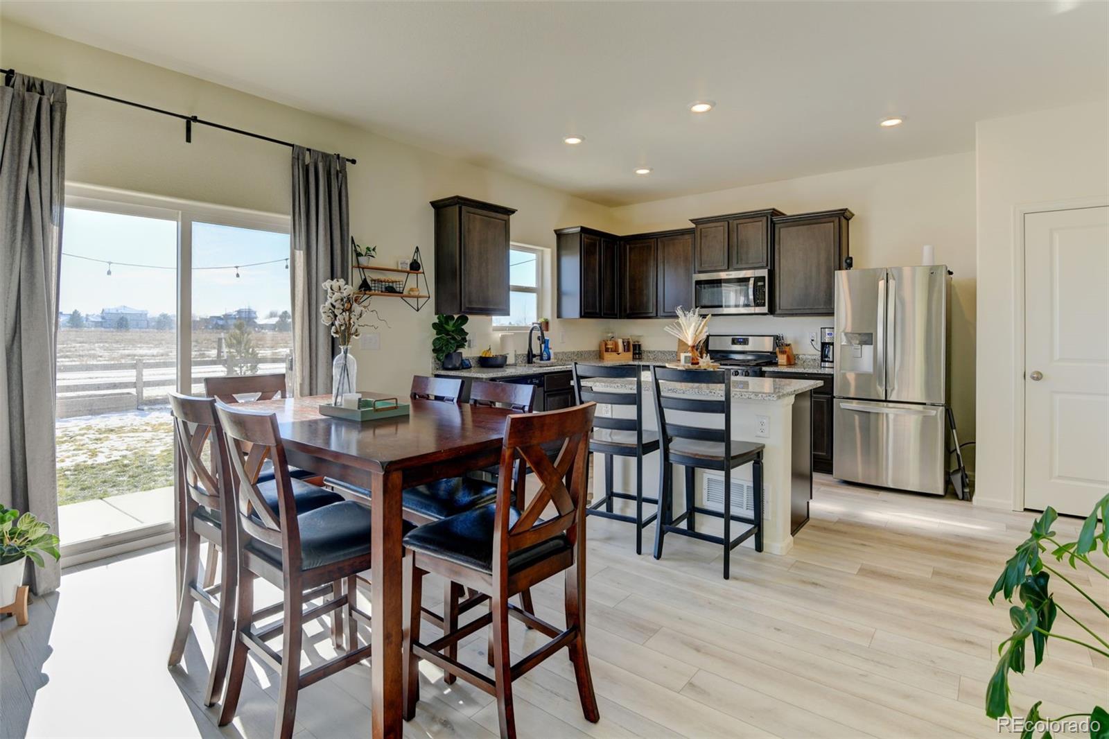 7252 Fall River Circle Frederick, CO 80530 - Photo 9 of 31 a view of a dining room with furniture window and wooden floor