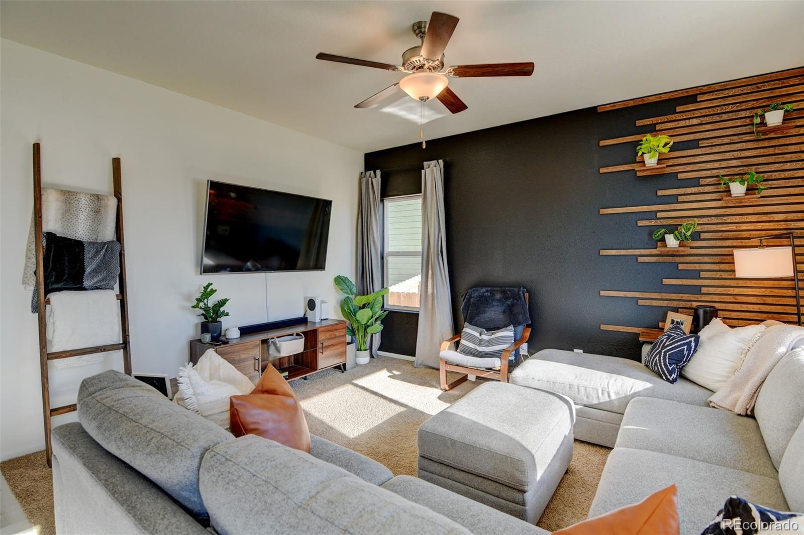 7252 Fall River Circle Frederick, CO 80530 - Photo 10 of 31 a living room with furniture and a flat screen tv