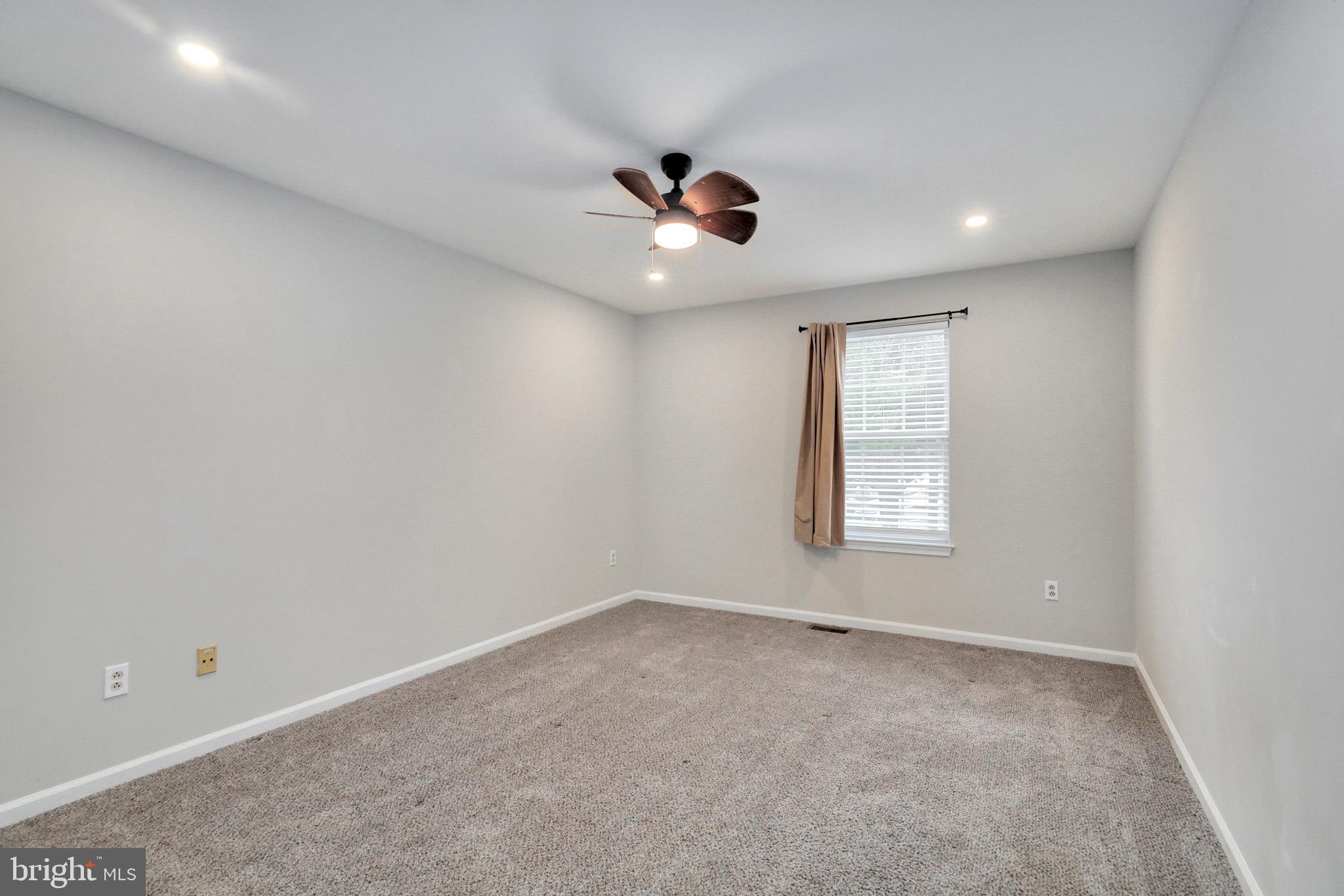 1804 Mason Run Pine Hill, NJ 08021 - Photo 20 of 32 an empty room with a window and a ceiling fan
