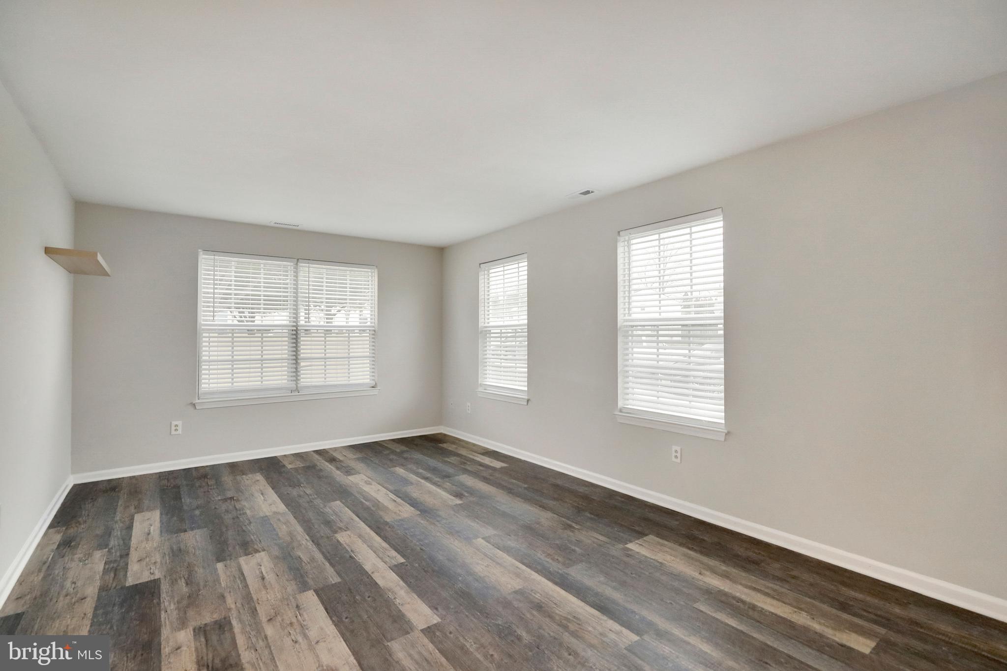 1804 Mason Run Pine Hill, NJ 08021 - Photo 10 of 32 an empty room with wooden floor and windows