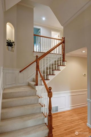 a view of entryway and hall with wooden floor