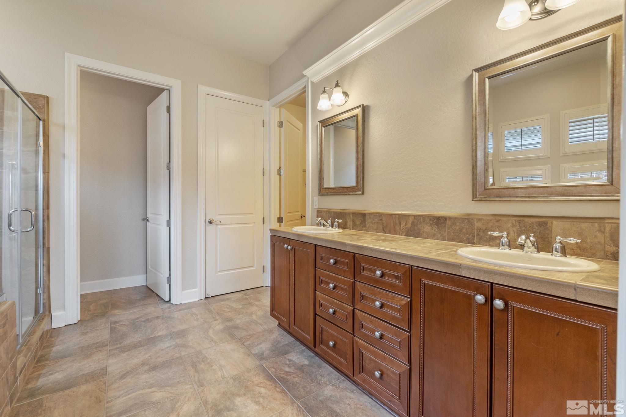 1225 Meridian Ranch Drive Reno, NV 89523 - Photo 29 of 40 a bathroom with a granite countertop double vanity sink mirror and