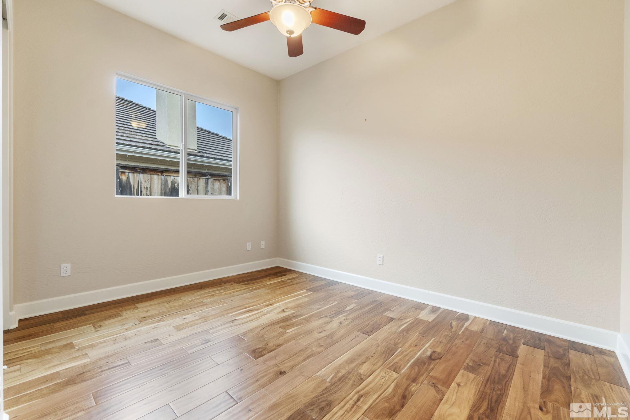1225 Meridian Ranch Drive Reno, NV 89523 - Photo 34 of 40 an empty room with wooden floor and windows