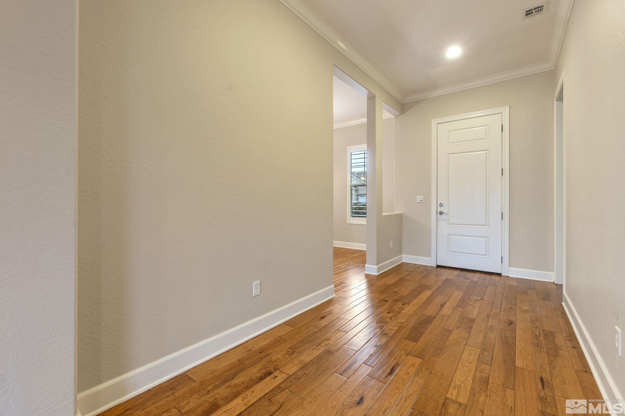 1225 Meridian Ranch Drive Reno, NV 89523 - Photo 4 of 40 an empty room with wooden floor and windows