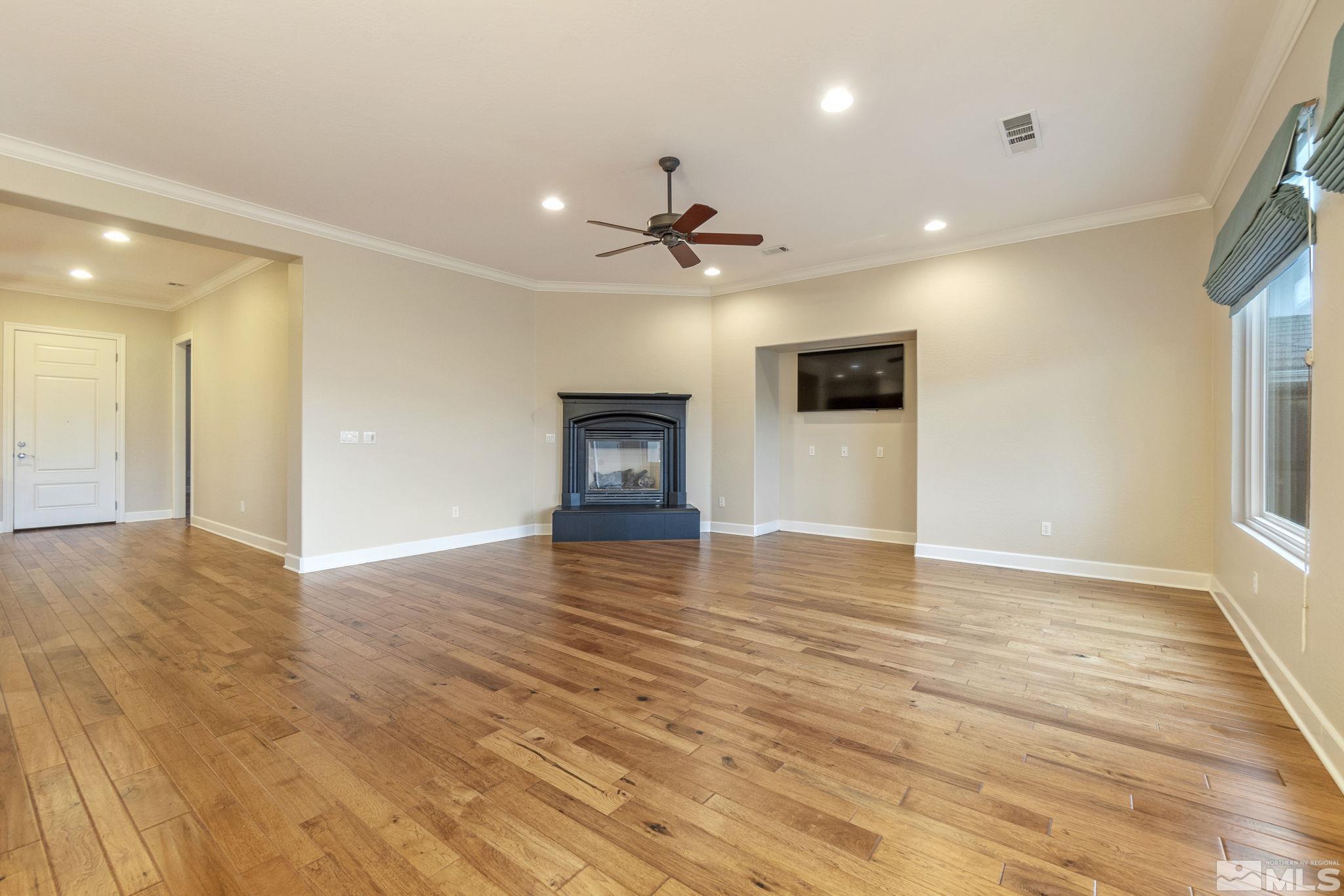 1225 Meridian Ranch Drive Reno, NV 89523 - Photo 8 of 40 a view of empty room with wooden floor and fan