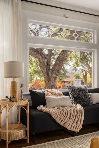 a dining room with furniture window and wooden floor