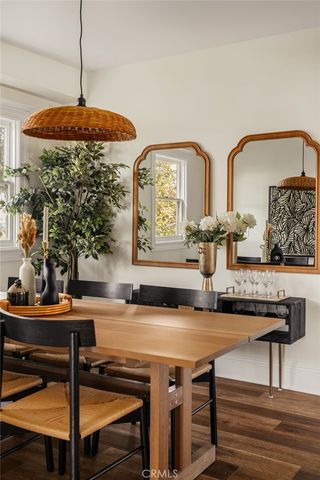 a kitchen with granite countertop a sink and stove with wooden floor