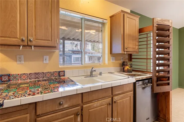 a kitchen with a sink a refrigerator and a stove