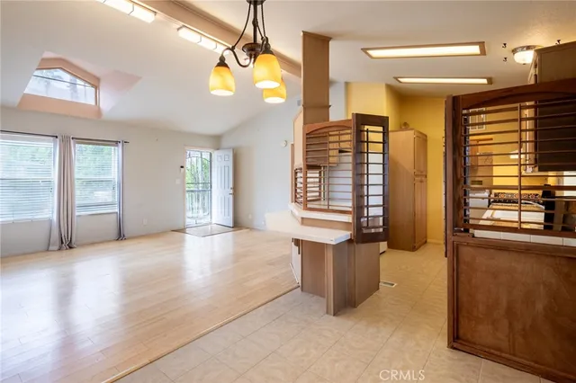 a view of an empty room with window and cabinet