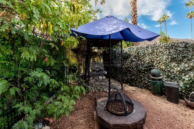 a backyard of a house with table and chairs