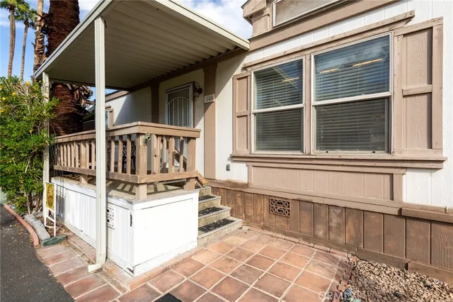 a front view of a house with swimming pool and glass windows