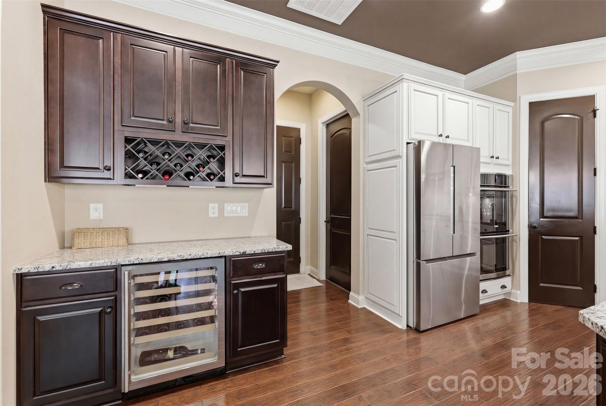 8094 Clems Branch Road Indian Land, SC 29707 - Photo 13 of 38 a kitchen with granite countertop wooden cabinets and stainless steel appliances