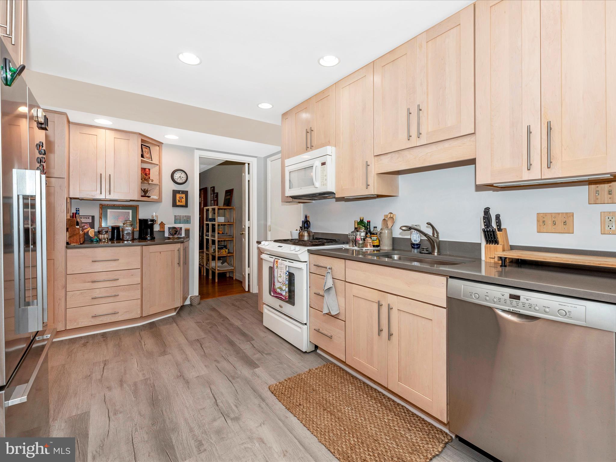 2479 Five Shillings Road Frederick, MD 21701 - Photo 12 of 52 a kitchen with stainless steel appliances granite countertop a refrigerator oven a sink and white cabinets with wooden floor