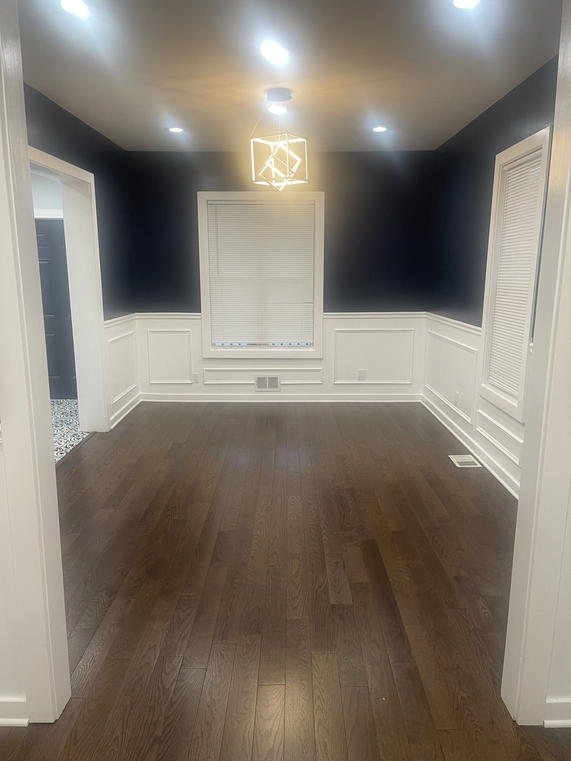 48 East 154th Street Harvey, IL 60426 - Photo 3 of 20 a view of an empty room with wooden floor