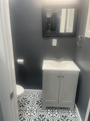 a bathroom with a sink a mirror and vanity