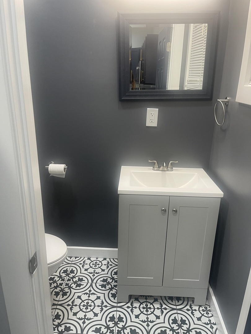 48 East 154th Street Harvey, IL 60426 - Photo 8 of 20 a bathroom with a sink a mirror and vanity