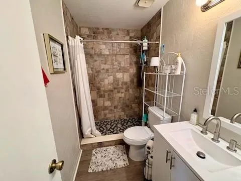 a bathroom with a sink toilet and shower