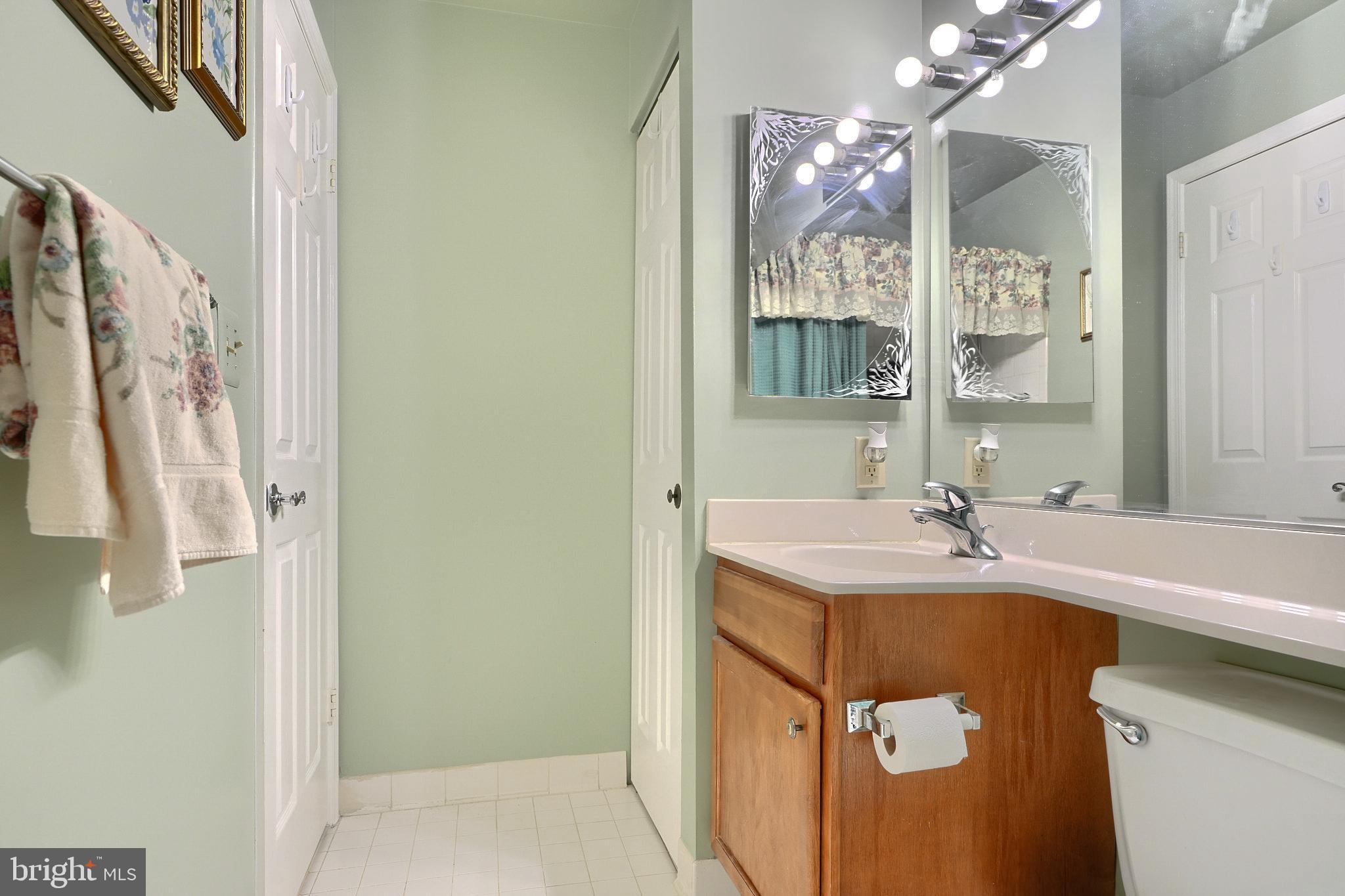 4102 Chardel Road, Unit 2H Nottingham, MD 21236 - Photo 11 of 21 a bathroom with a sink mirror and a shower