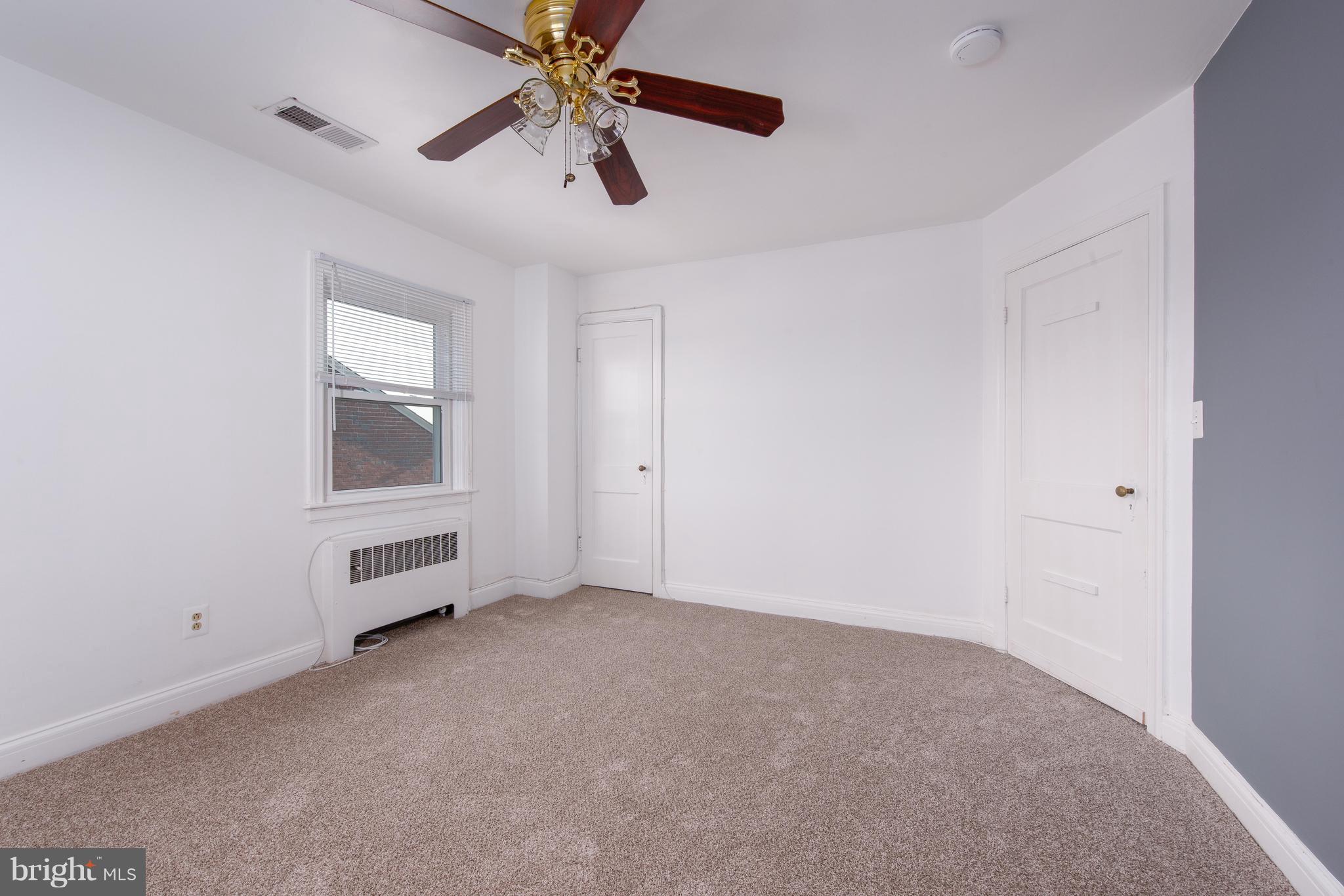 3818 Rexmere Road Baltimore, MD 21218 - Photo 14 of 25 an empty room with windows and fan