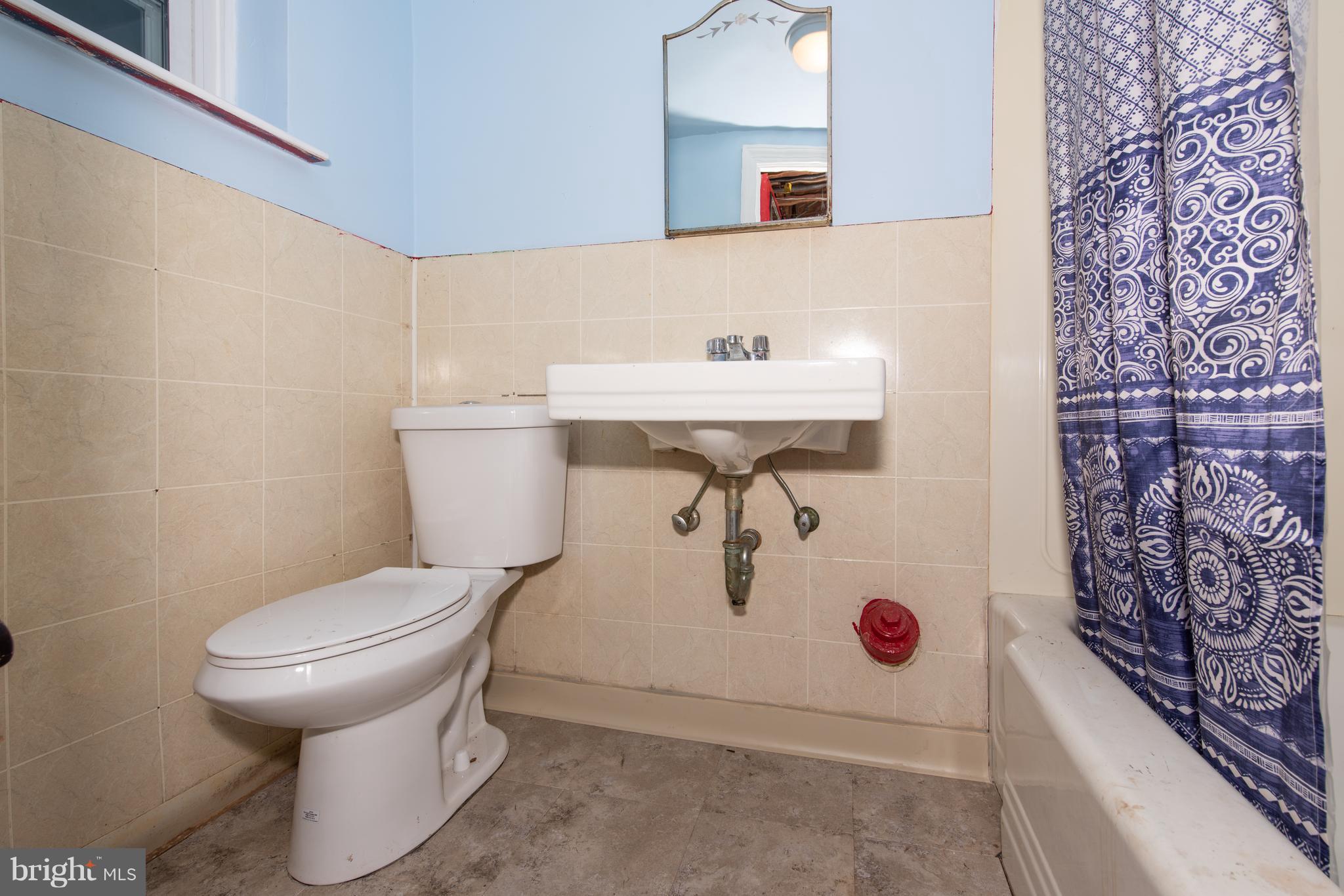 3818 Rexmere Road Baltimore, MD 21218 - Photo 18 of 25 a bathroom with a sink toilet and mirror