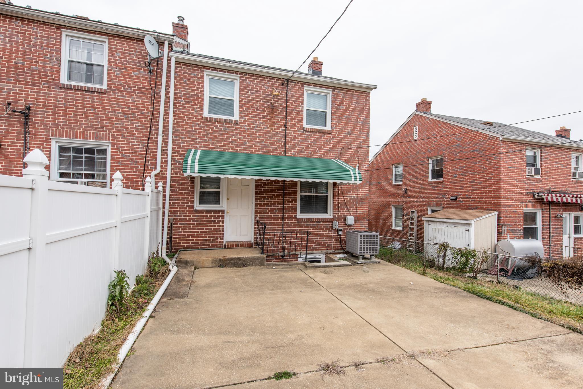 3818 Rexmere Road Baltimore, MD 21218 - Photo 24 of 25 a front view of a house with a yard