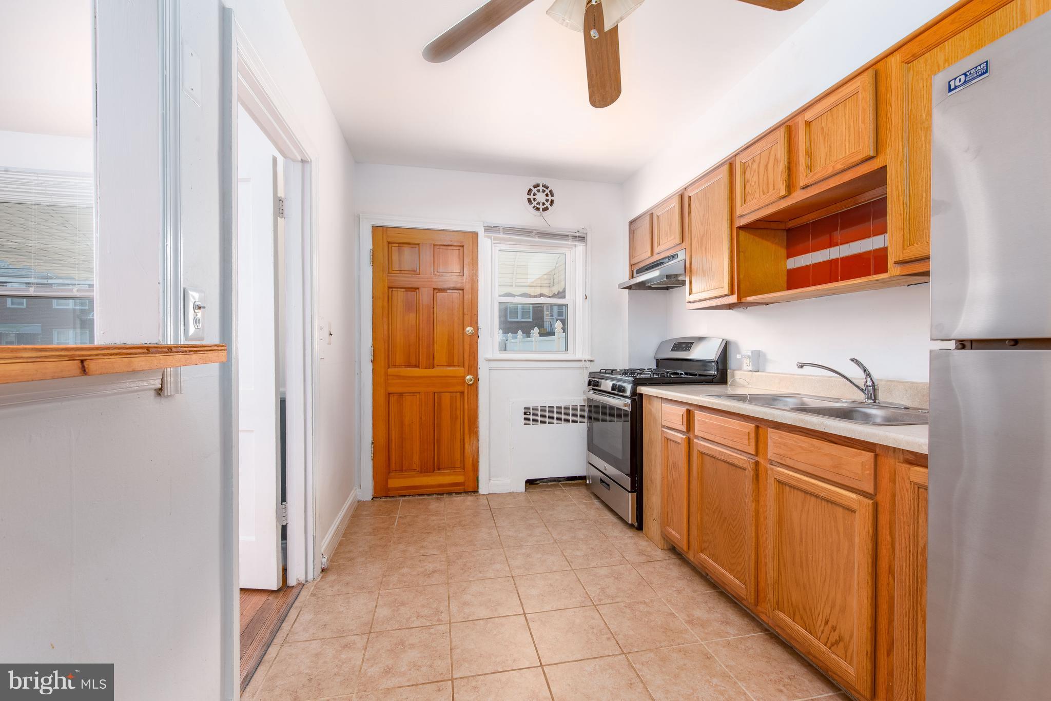 3818 Rexmere Road Baltimore, MD 21218 - Photo 7 of 25 a kitchen with stainless steel appliances granite countertop a refrigerator and a sink