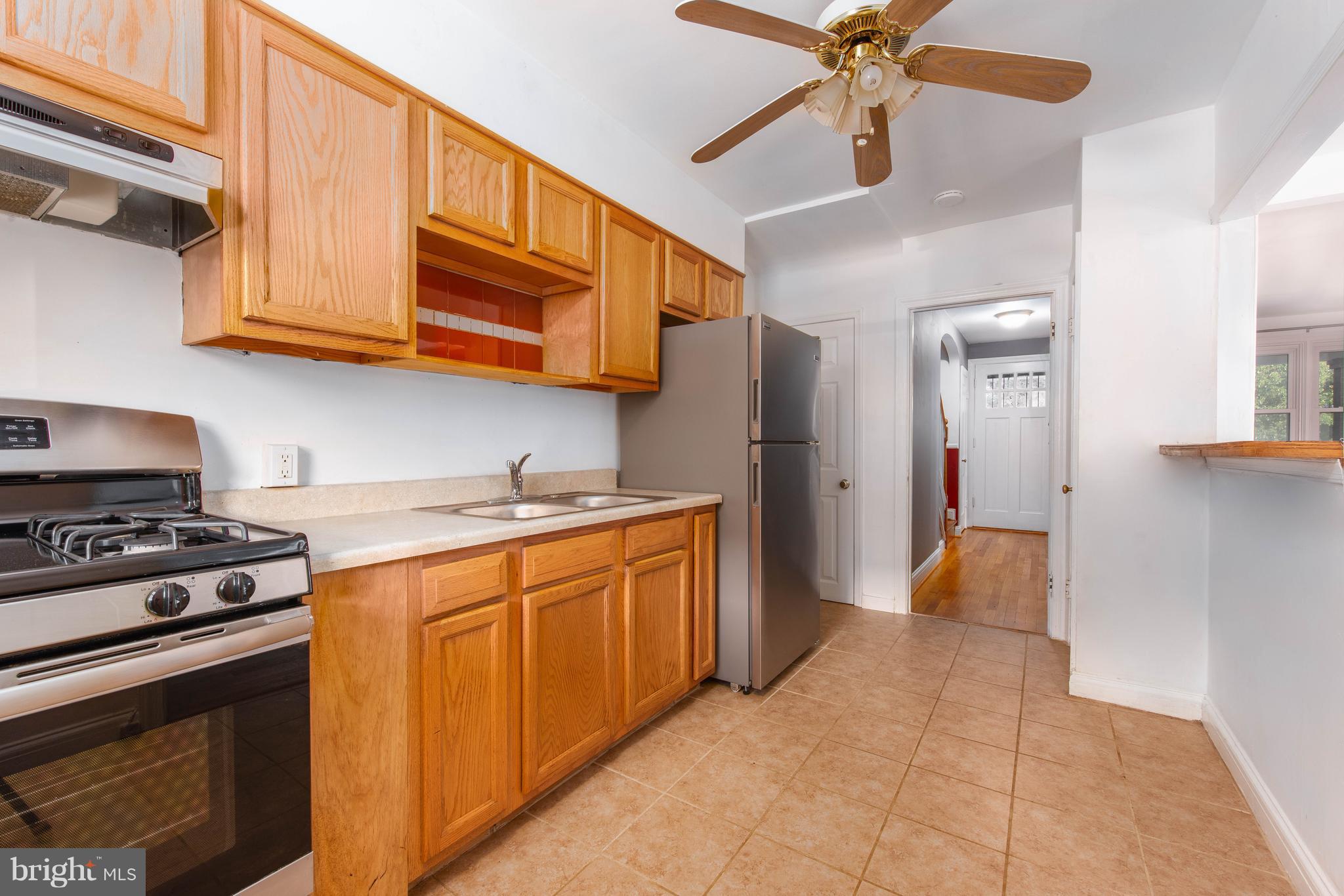 3818 Rexmere Road Baltimore, MD 21218 - Photo 8 of 25 a kitchen with stainless steel appliances granite countertop a stove cabinets and refrigerator