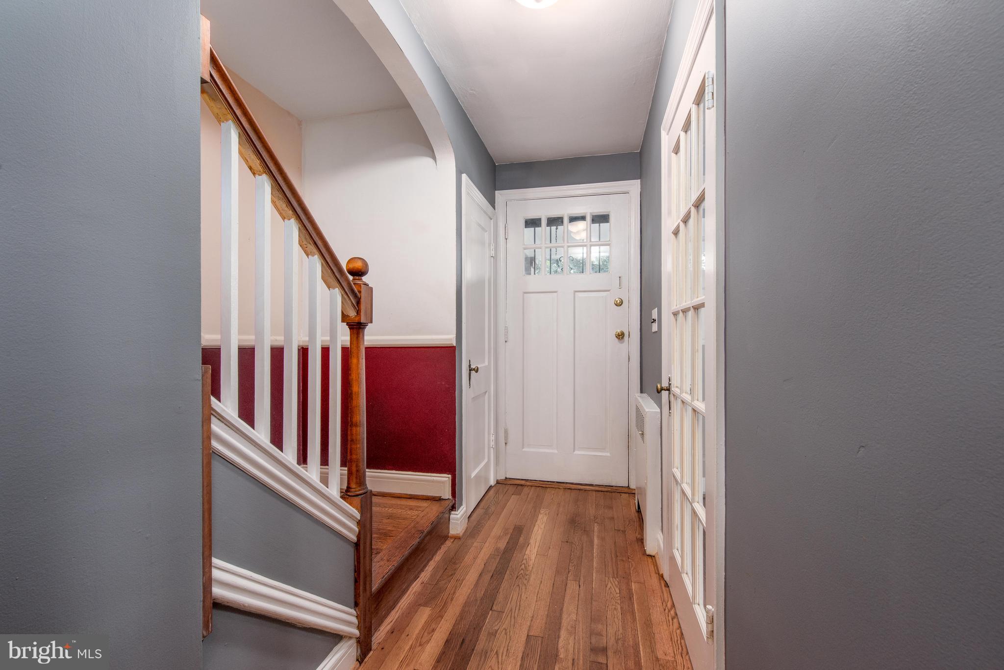 3818 Rexmere Road Baltimore, MD 21218 - Photo 9 of 25 a view of a hallway with wooden floor and staircase