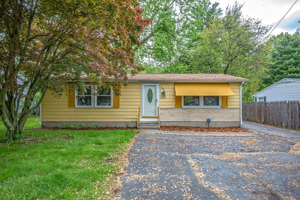 1101 Allen Street Springfield, MA 01118 - Photo 2 of 29 a front view of a house with a yard and garage