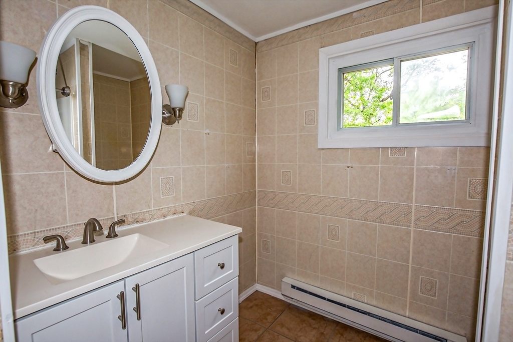 1101 Allen Street Springfield, MA 01118 - Photo 23 of 29 a bathroom with a sink a toilet and a mirror