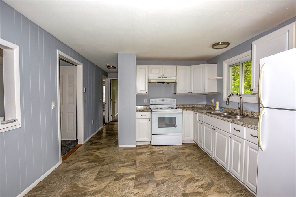 1101 Allen Street Springfield, MA 01118 - Photo 4 of 29 a kitchen with granite countertop white cabinets and white appliances