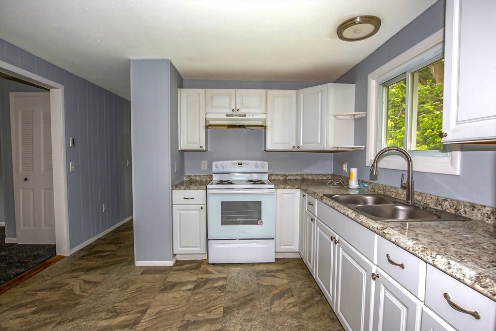 1101 Allen Street Springfield, MA 01118 - Photo 5 of 29 a kitchen with a stove a sink and a window