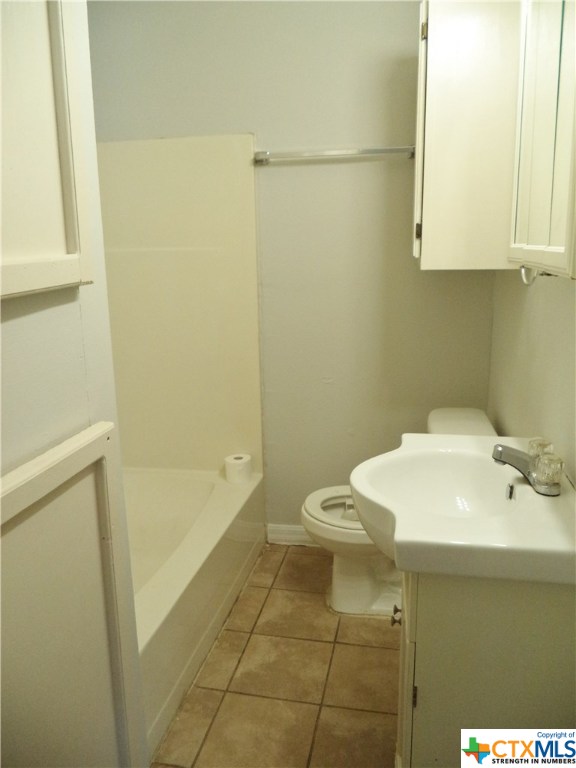 1310 West Broadway Avenue Seadrift, TX 77983 - Photo 4 of 7 a bathroom with a sink a toilet and shower