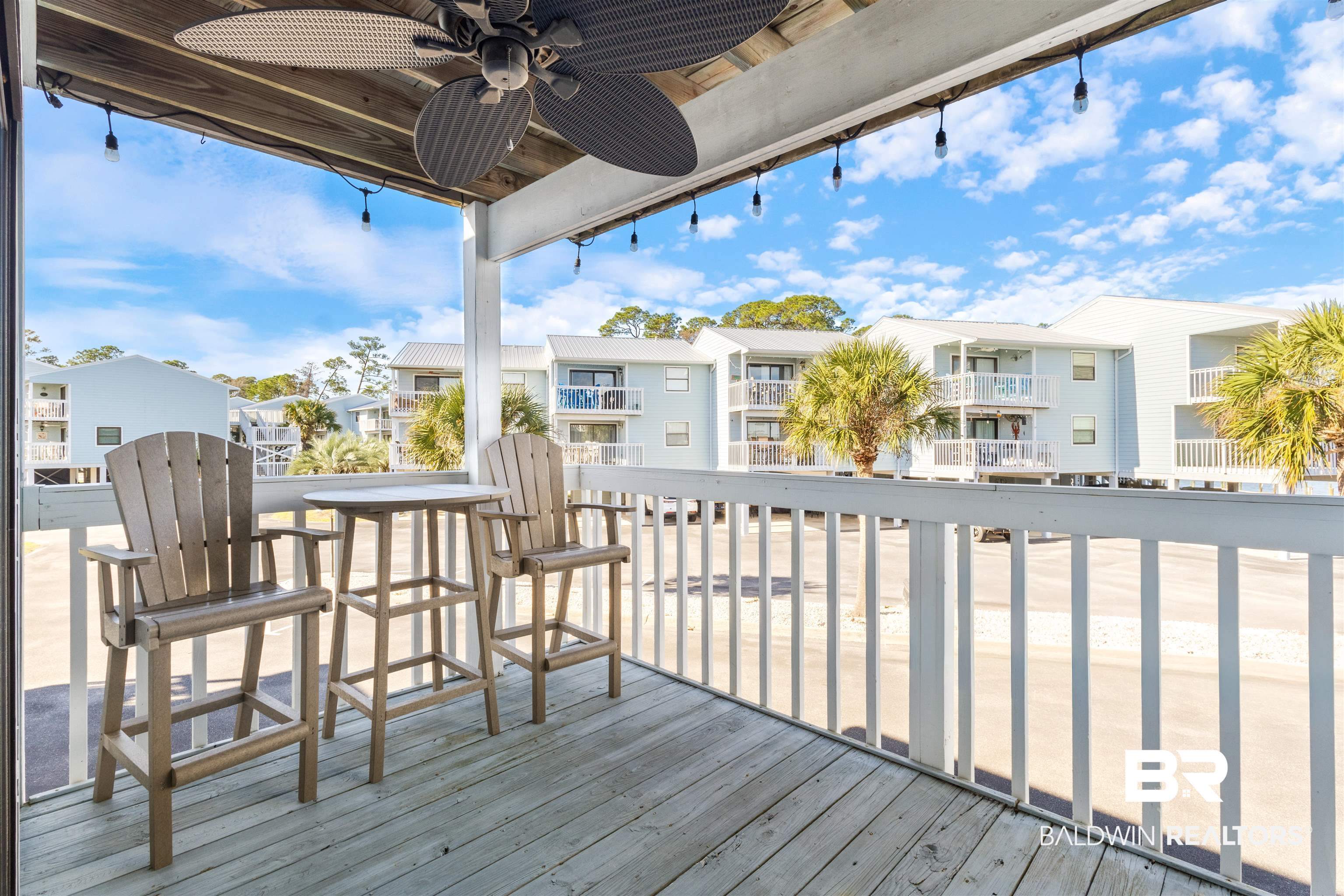 25861 Canal Road, Unit 3 Orange Beach, AL 36561 - Photo 21 of 40 Wooden terrace with ceiling fan and a residential view