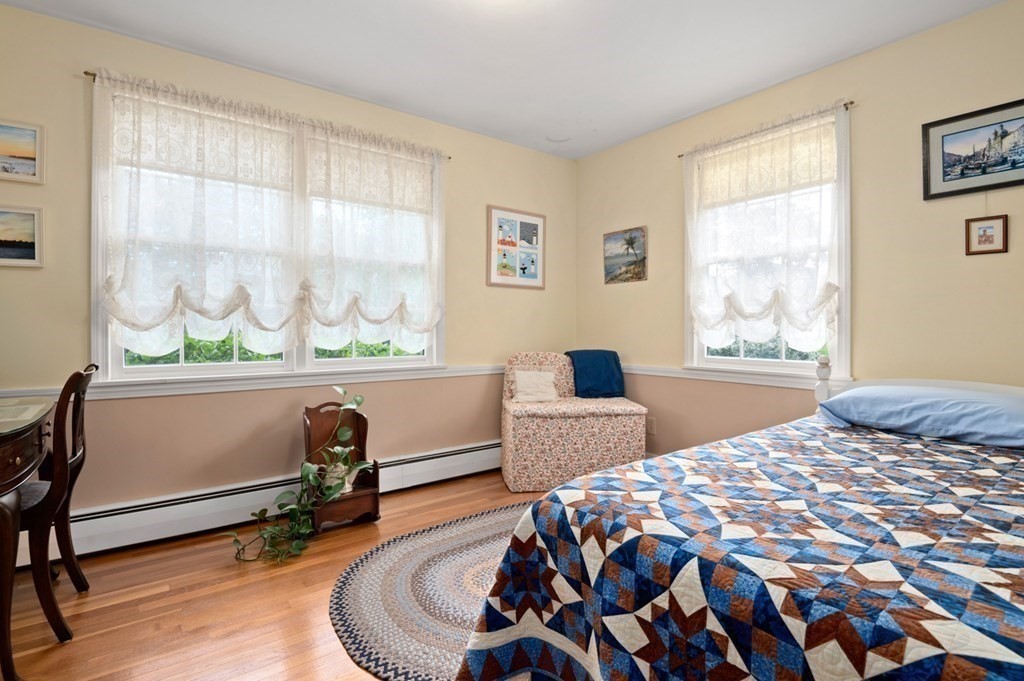 7 Hanover Drive Newbury, MA 01951 - Photo 17 of 33 a bedroom with a bed window and a table in it