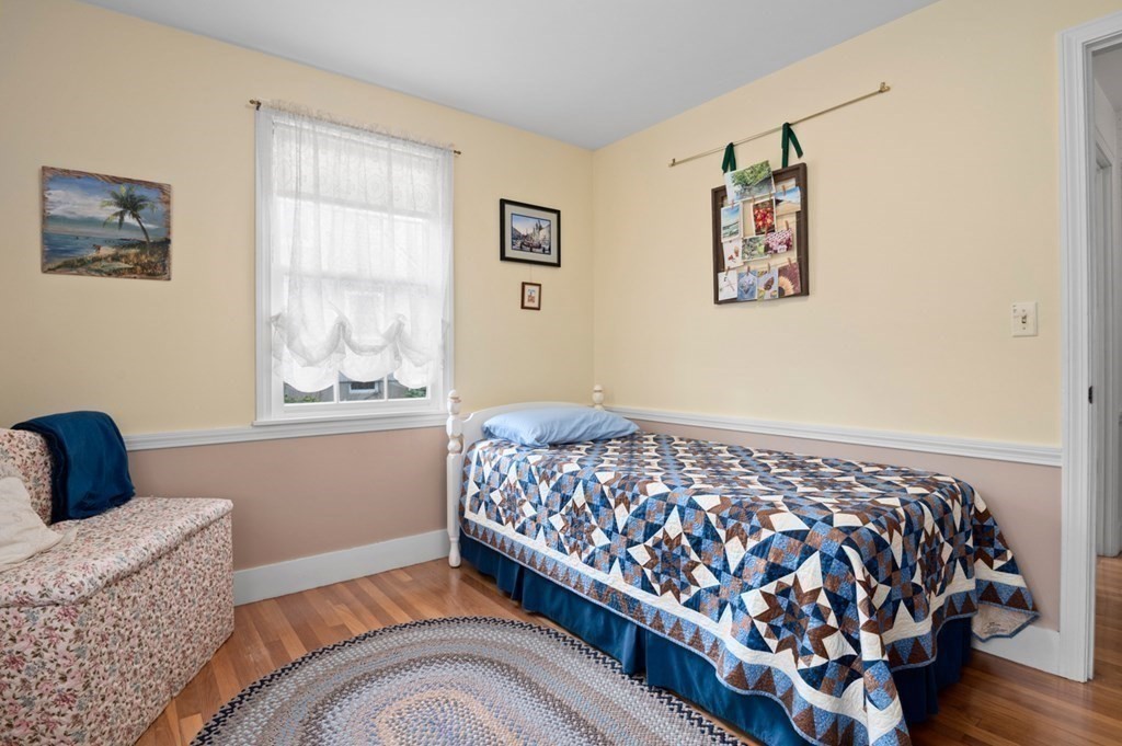 7 Hanover Drive Newbury, MA 01951 - Photo 18 of 33 a bedroom with a bed and wooden floor