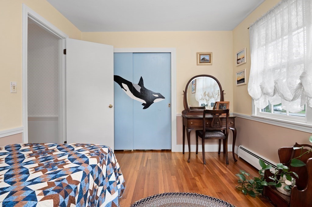 7 Hanover Drive Newbury, MA 01951 - Photo 19 of 33 a bedroom with a bed and a table in it