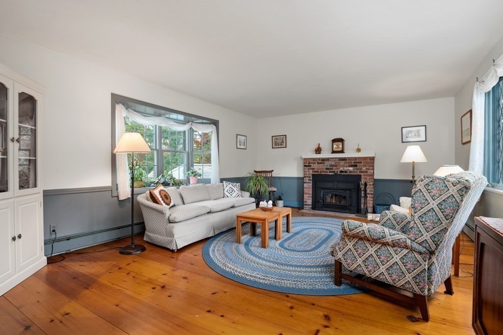 7 Hanover Drive Newbury, MA 01951 - Photo 3 of 33 a living room with furniture a fireplace and a large window