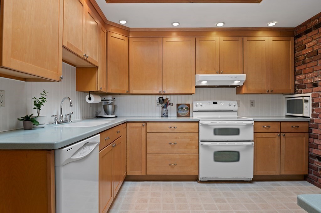 7 Hanover Drive Newbury, MA 01951 - Photo 8 of 33 a kitchen with stainless steel appliances granite countertop a sink a stove and a refrigerator