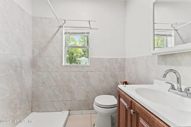 a bathroom with a sink a toilet and a window