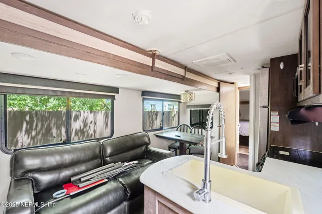 a living room with furniture and a floor to ceiling window
