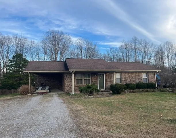 a view of a house with a yard and plants