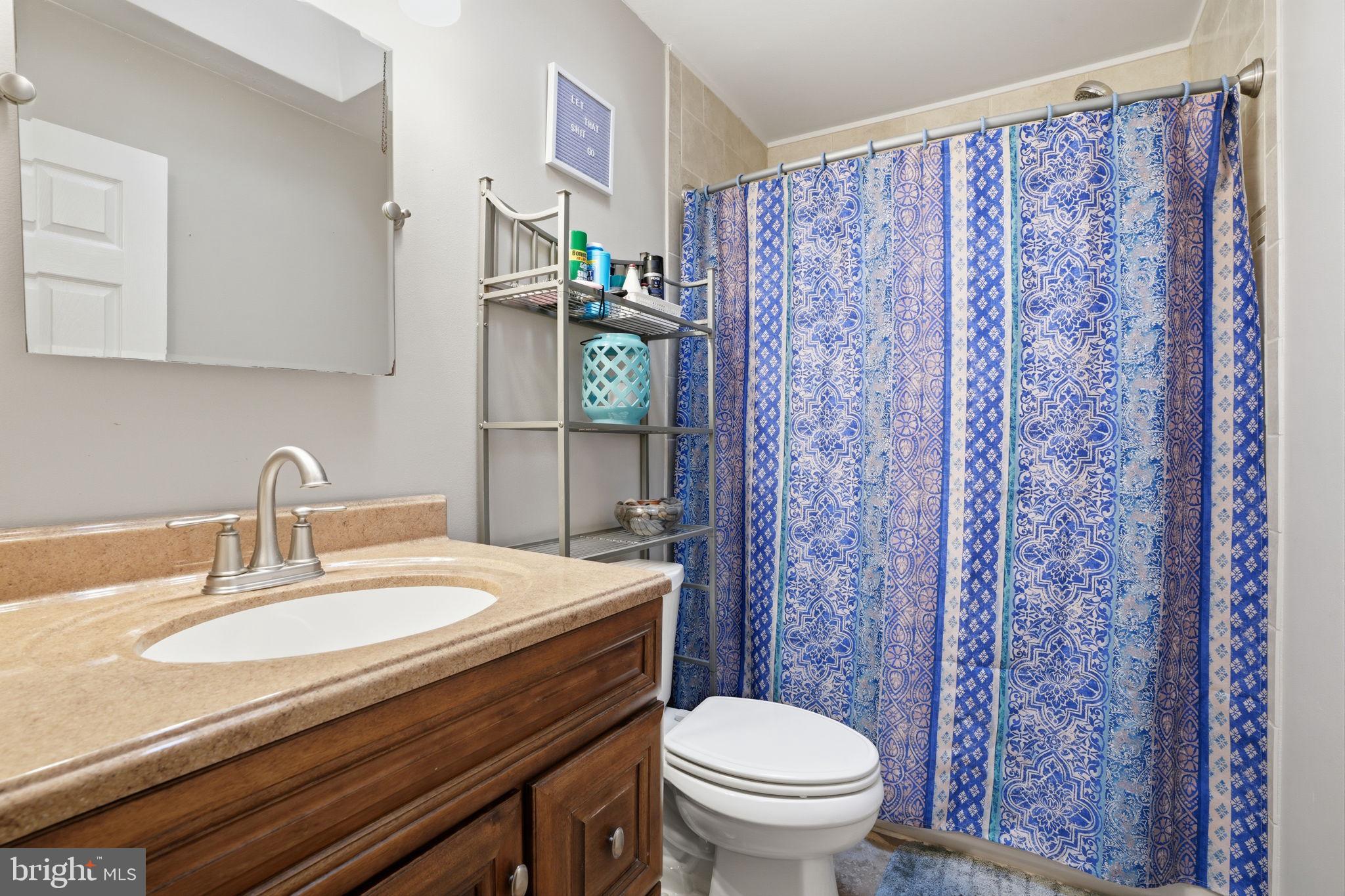 2824 Willits Road Philadelphia, PA 19136 - Photo 13 of 22 a bathroom with a granite countertop sink and a toilet